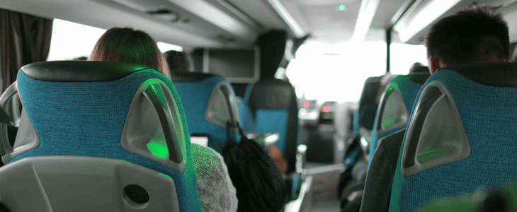 Back view of passengers sitting in a charter bus 